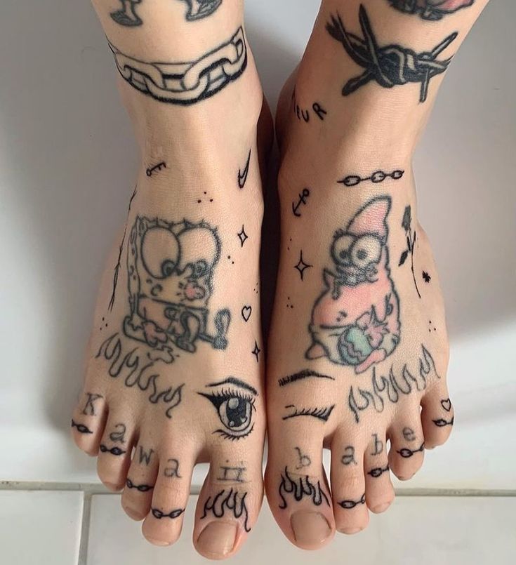 two people with tattoos on their feet