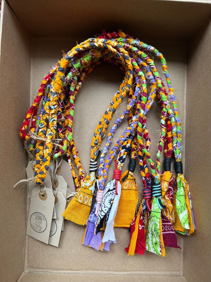 a box filled with lots of different colored ribbons