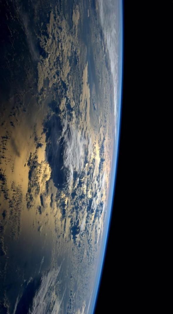 the earth seen from space showing clouds and land