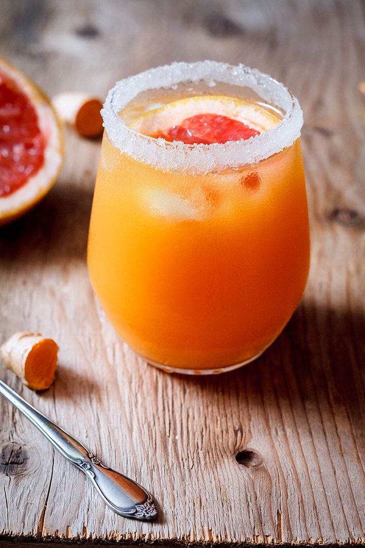 a grapefruit cocktail is garnished with sugar