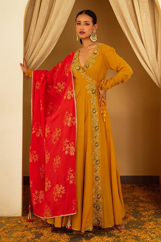 Ochre angrakha anarkali with sequin embellished floral motif border. Comes with churidar and coral dupatta.
Components: 3
Pattern: Embroidered
Type Of Work: Floral
Neckline: V-neck
Sleeve Type: Full
Fabric: Cotton Silk, Handwoven Kota Doriya
Color: Yellow
Other Details: 
Side tasselled drawstring
Occasion: Sangeet,Cocktail - Aza Fashions Angrakha Anarkali, Stylish Watches For Girls, Churidar, Embroidered Silk, Set For Women, Anarkali, Cotton Silk, Aza Fashion, Floral Motif