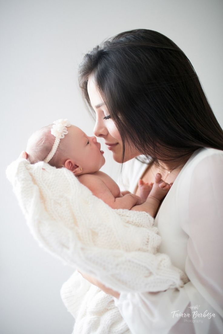 a woman holding a baby in her arms