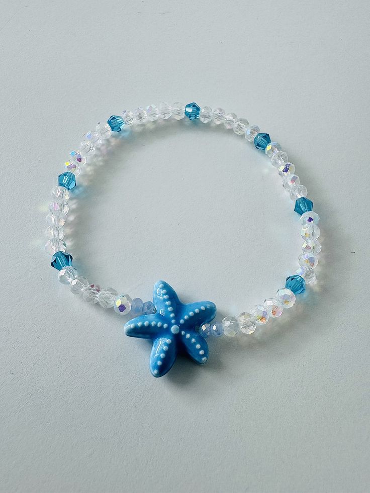 This will come with the pattern and color beads in the picture, and a blue starfish. This bracelet will come 7 inches long ( standard women's wrist) The bracelet is also made with stretchy string. This will also come with a satin bag and a polishing cloth. ANY QUESTIONS AT ALL OR CUSTOM ORDERS PLEASE DON'T HESITATE TO MESSAGE ME I WILL GET BACK TO YOU ASAP! -Please roll-on bracelets to avoid   over-stretching. -As with any bead that is not a precious  metal you should not expose your bracelets  to water or direct sun also natural body oils,  lotions, and other materials could cause   discoloration. -Each bracelet is handmade with love by me so no two will be exactly the same. FREE SHIPPING ON ORDERS OF $35 OR MORE Cheap Beaded Bracelets With Heart Beads For Beach, Turquoise Starfish Beaded Bracelets, Ocean-inspired, Ocean-inspired Turquoise Starfish Beaded Bracelets, Blue Bracelets With Starfish Charm Ocean-inspired, Ocean-inspired Blue Starfish Bracelets, Starfish Shaped Beaded Bracelets For Beach Season, Adjustable Blue Bracelets With Starfish Charm, Blue Beaded Bracelet With Starfish Charm, Blue Starfish Beaded Bracelets For Vacation