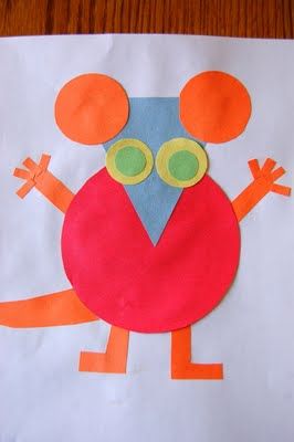 a paper bag with an orange and blue bird on it's face, made to look like a mouse