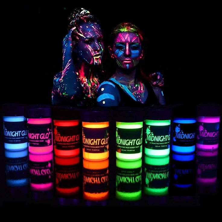 two people are standing next to each other with neon paint