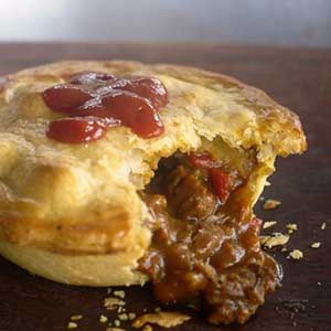 a piece of meat pie with sauce on it