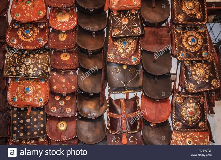 handmade leather bags and purses for sale at a market stall