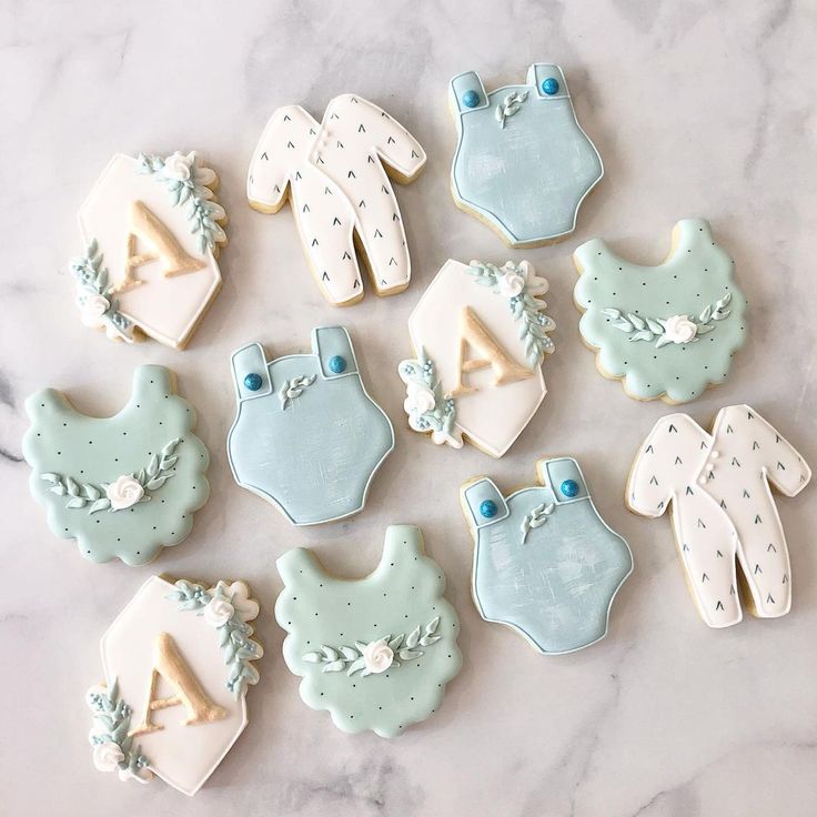 decorated cookies are laid out on a marble surface