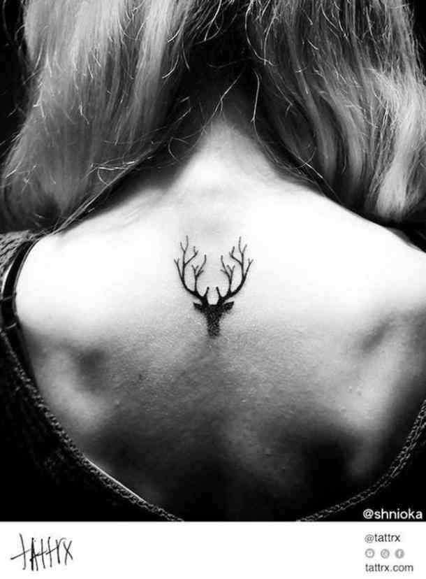 a woman with a deer tattoo on her back