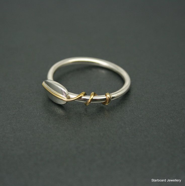 Enchanting sterling silver ring with silver leaf and brass detail. A polished round wire band with a silver leaf which has a brass vein wrapping around the band creating this very striking contrast. The ring is very comfortable to wear and stacks well against other rings in the Starboard collection. UK finger sizes J to T Other sizes on request All my jewellery comes in a presentation gift box. All my designs are hand made and no two are exactly the same. Thanks for your time. Silver Dainty Brass Rings, Unique Silver Stackable Brass Rings, Silver Brass Stackable Rings For Promise, Dainty Silver Brass Rings, Silver Brass Midi Rings For Anniversary, Silver Brass Open Ring Stackable Rings, Handmade Silver Midi Rings In Brass, Silver Leaf Ring, Silver Jewlery