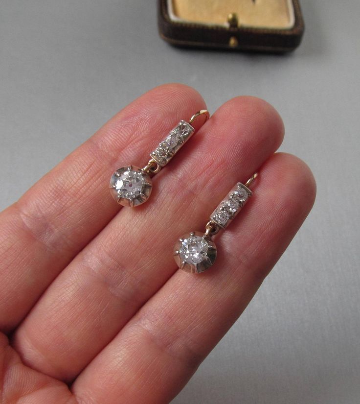 Antique 14K yellow and white gold drop earrings with diamonds, lever back. With an Austrian hallmark that was used between 1867 and 1937. Gemstone: Natural diamond, 2 pieces Weight: 1.3 carat Color: Crystal (I/J) Clarity: SI2 Measurements: Round, 5.8 x 3.16 mm each Cut: Old Cut Brilliant Finish: Corresponds to old cut requirements Fluorescence: none Not treated. Additional stones: Natural diamond, 6 pieces Measurements: 2.4 mm Weight: 0.3 carat Cut: Old Cut Brilliant Color: Crystal (I/J) Clarity Classic Hallmarked Diamond Earrings, Art Deco White Gold Diamond Earrings With Brilliant Cut, Classic Hallmarked Diamond Earrings For Formal Occasions, Classic Hallmarked Diamond Earrings For Formal Events, Art Deco Diamond Earrings Hallmarked, Vintage White Diamond Earrings, Vintage White Diamond Earrings For Formal Occasions, Antique Brilliant Cut Diamond Earrings, Victorian Diamond White Diamond Earrings For Formal Occasions