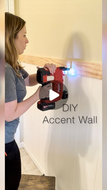 a woman using a driller on the wall with text that reads diy accent wall