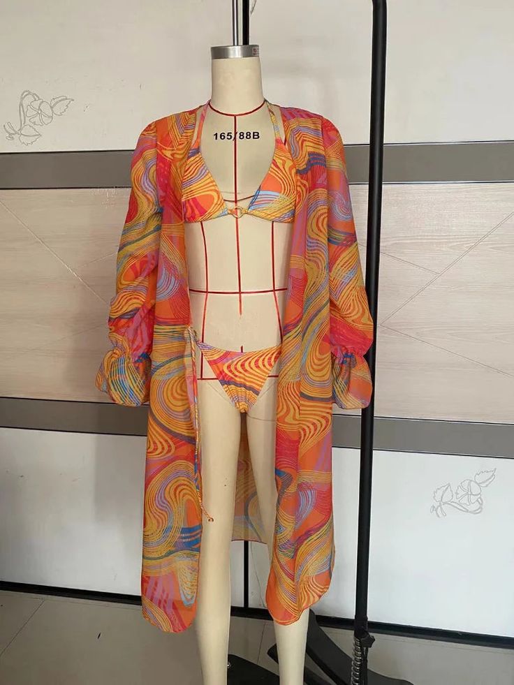 a mannequin wearing a colorful dress and jacket