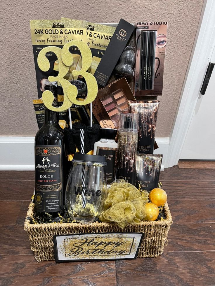 a basket filled with wine, liquor and other items sitting on top of a wooden floor