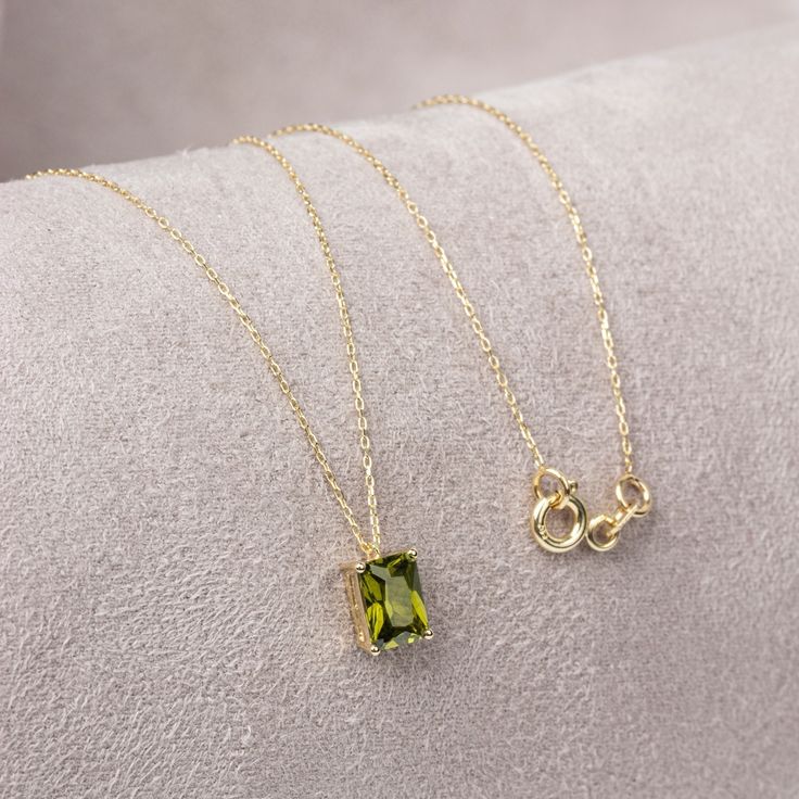 "With its shimmering pale green color, peridot stone is also known as the \"evening emerald\". It is a gemstone often associated with spirituality and expression. Our 14k solid gold peridot necklace is a stylish jewel for you and your loved ones with its elegant design. Time to pamper yourself and your loved ones... Peridot is the birthstone of August. 🤍🤍 Special gifts for your special moments. We produce our jewelery for you in the most perfect way. 🤍🤍 All of our products are made of 14K So Peridot Necklace Gold, Elegant May Birthstone Necklace With Rectangular Stone, Green Square Pendant Minimalist Jewelry, Minimalist May Birthstone Jewelry In Rectangular Shape, Minimalist Green Necklace With Square Pendant, Green Square Pendant Necklace In Minimalist Style, Green Square Pendant Minimalist Necklace, Minimalist Green Square Pendant Necklace, August Birthstone Necklace