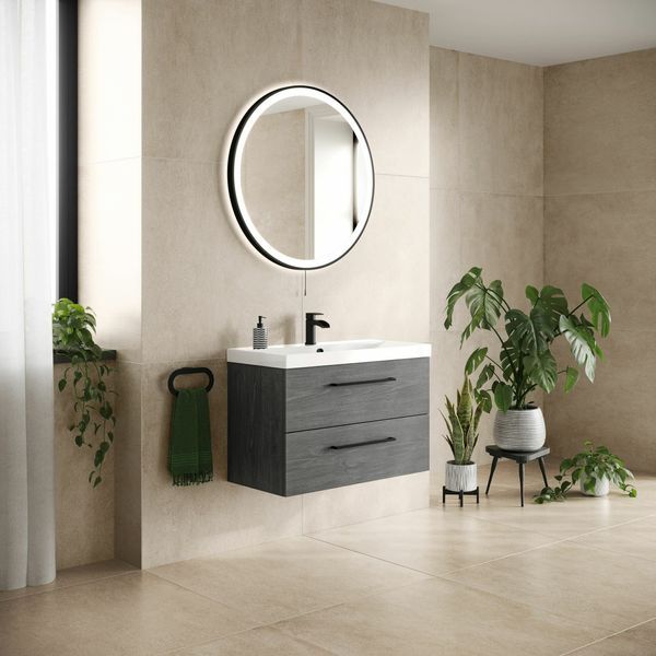 a bathroom with a sink, mirror and potted plant on the floor in front of it