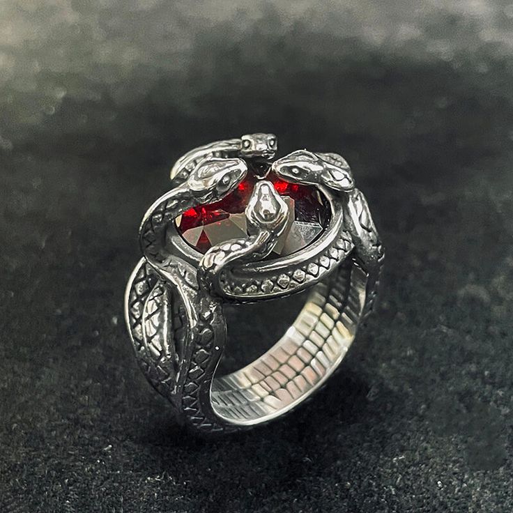 🎁Made from durable stainless steel, this ring features a design of four snakes intricately twisted and wrapped around a central red zircon stone. Adjustable Gothic Snake Ring For Gift, Adjustable Gothic Snake Ring As Gift, Snake Shape Metal Ring As Gift, Snake-shaped Metal Rings As A Gift, Unique Red Metal Rings, Red Snake-shaped Jewelry For Gifts, Fantasy Rings Magic, Fantasy Rings, Power Rings