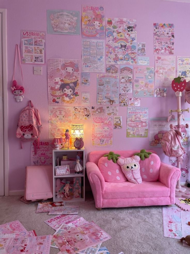 a room with pink furniture and posters on the wall