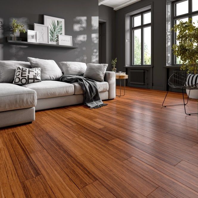 a living room filled with furniture and large windows next to a wooden floored floor