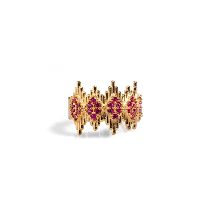 Ruby Stone & Gold Crown Adjustable Statement Ring, a luxurious and elegant piece designed to add a touch of royalty to your style. Crafted from 24k gold-plated brass, this stunning ring features geometric crown-like lines adorned with delicate ruby stones, creating a refined yet striking effect. The intricate design captures a regal aesthetic, making it both a sophisticated and eye-catching accessory. With its adjustable band, this ring offers versatility and comfort, making it perfect for any occasion Details Crafted with high-quality brass and plated with 24k gold for a luxurious finish. Ruby stone Adjustable size Avoid contact with chemicals, makeup, perfume. Do not use dips or abrasive cleaners on ring. To clean and brighten it up your ring, wipe them gently with jewelry polishing clot Luxury Pink Gold-plated Jewelry, Luxury Gold-tone Brass Rings, Yellow Gold Jeweled Rings As Gifts, Yellow Gold Temple Jewelry Rings For Formal Events, Luxury Gold Ruby Birthstone Ring, Yellow Gold Rings With Jewels For Gift, Formal Yellow Gold Temple Jewelry Rings, Gold Ruby Rings With 17 Jewels, Luxury Pink Gold Ruby Ring