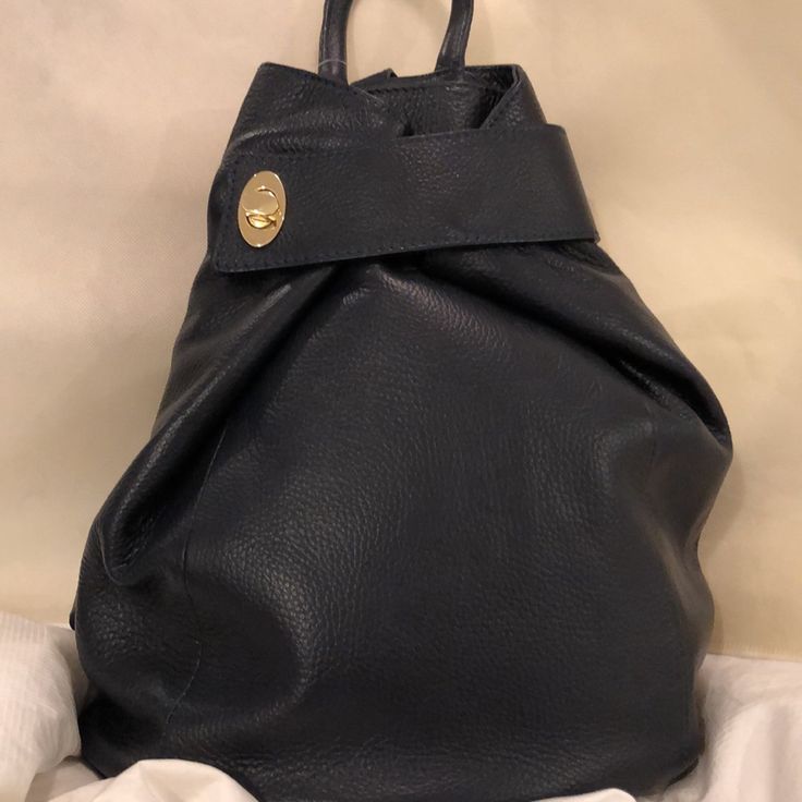 Stylish Handbag Backpack All Leather Deep Navy, Could Serve As Black As Well Gold Tone Hardware Zipper Closure With Additional Toggle Wrap At Top Adjustable Leather Back Straps Hand Carry As Well 4” Drop Zipper Phone Pocket On Back For Added Security Interior Has Zipper Pocket And Slip Pocket Roomy Inside Purchased At A Boutique - No Brand Name On Bag Generic Dust Bag Included Nwt Excellent Condition Luxury Backpack With Double Handle For Daily Use, Designer Tote Backpack For Everyday Use, Designer Shoulder Bag Standard Backpack For Everyday Use, Designer Everyday Backpack Tote, Designer Everyday Tote Backpack, Designer Shoulder Bag As Standard Backpack For Everyday Use, Designer Backpack For Everyday Use, Designer Everyday Standard Backpack, Designer Leather Backpack With Removable Pouch