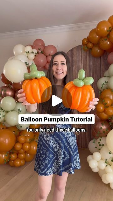 a woman holding up two pumpkins in front of balloons and an arch with the words balloon pumpkin tutor you only need three balloons