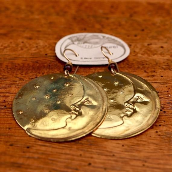 There are quite a few moonface earrings in Laurel's line - this one has the distinction of being the first. Brass with sterling gold-plate, about 2" (2 1/2 fingers) tall.The revival earrings here are vintage stock from the 1970's - they were designed by the late artist Laurel Burch and crafted by hand.