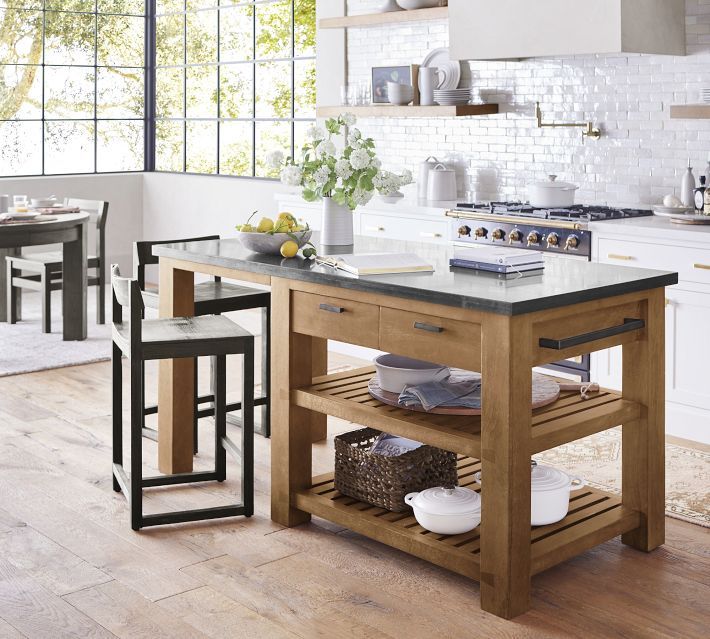 a kitchen island with two stools next to it