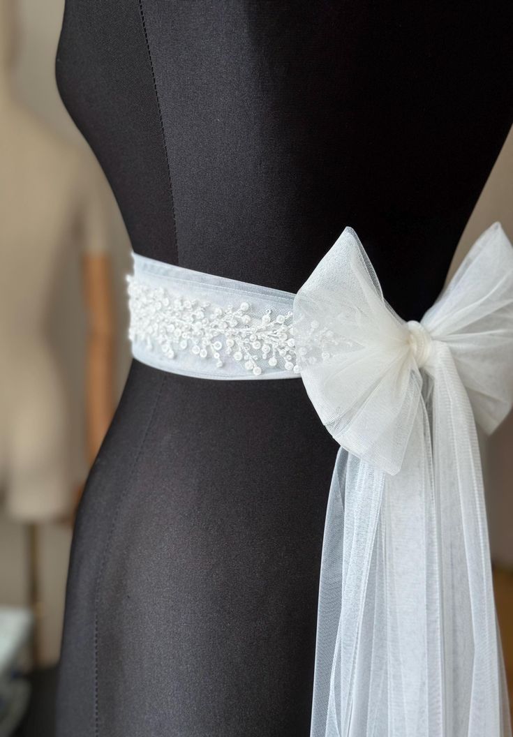 A stunning, elegant statement wedding sash is exquisitely beaded in beautiful vintage pattern. Your choice tulle  sash is attached to the beading and ties at the back into a bow.  An ultimate luxurious accent piece for your wedding dress or for any special occasion dresses. Accentuate your waist and add a touch of feminine charm to any dress with this tulle sash. Even the most simple gown can transform into a dreamy ensemble with this voluminous bow. Color embroidery - ivory or white Color tulle may be different  - white, ivory... and other Bead embroidery length 50 cm The belt is made as a long ribbon that you can tie around your waist. Belt For Gown Dress, Embroidery Belt For Gown, Belt For Wedding Dress Bridal Sash, Wedding Bridal Accessories, Simple Wedding Dress Accessories, Satin Ribbon Belt, Belted Wedding Dress, Wedding Dress Belts And Sashes, White Princess Gown