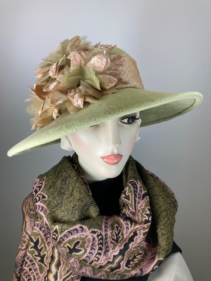 This hat would be right at home on Downton Abbey! The color is a really pretty pistachio green. It is topped with a light tan silk band that coordinates perfectly! Embellished with three vintage silk and velvet flowers. The brim shape is a soft oval and the sides are longer than the front; the back is much narrower at 2 1/4 inches. It is hand blocked using traditional millinery techniques, including steaming, shaping, and hand sewing. ++++++++++++++++++++++++++++++++++++++++++++++++++++++FIT AND Spring Wool Hat With Flat Brim, Evening Hats With Curved Brim For Fall, Curved Brim Evening Hat For Fall, Evening Fall Hat With Curved Brim, Wool Brimmed Top Hat For Kentucky Derby, Brimmed Cloche Hat For Church In Winter, Evening Hats With Flat Brim For Fall, Winter Brimmed Cloche Hat For Church, Winter Church Brimmed Cloche Hat