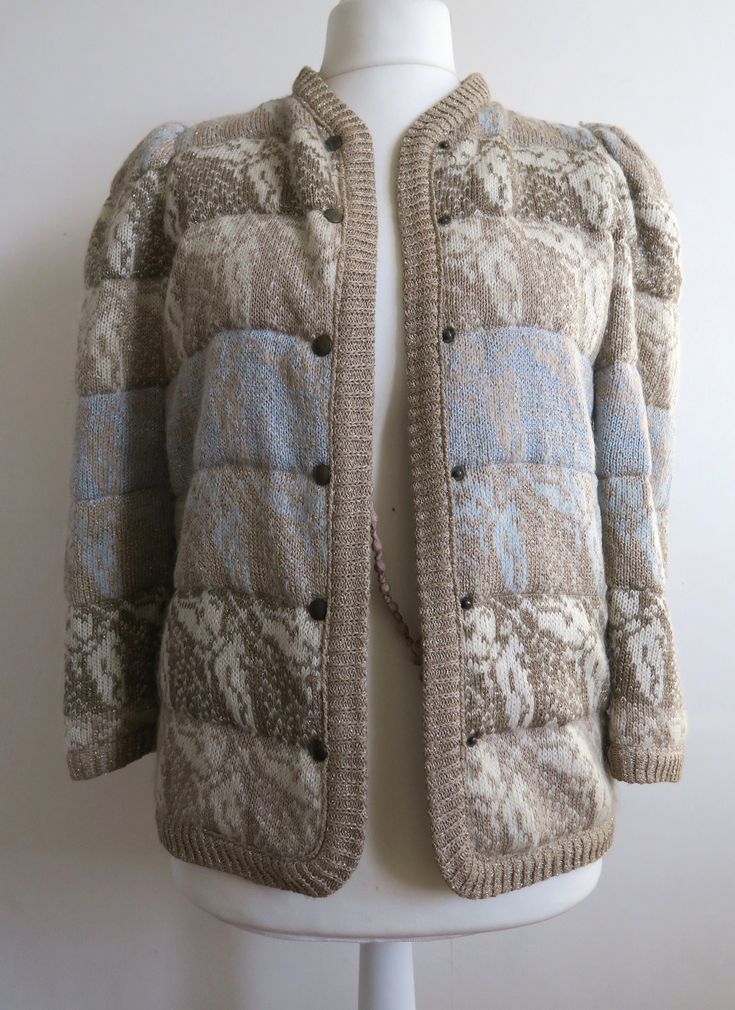 "Luxurious knitted and quilted jacket with golden lurex threads going all through. Butterfly pattern all over. The colors are shades of beige, white and blue. The color shift comes in horizontal stripes. Remember that there is that golden lurex as well! The jacket is hip length, got high crew neck and puffy sleeves. It's lined and and got snaps up the front. Estimated size Small for relaxed fit. The dress shape is Medium, and the jacket is clearly too small for it. Please check the measurements: armpit  ~ 94 cm  /  ~ 37 \" waist  ~ 94 cm  /  ~ 37 \" length  ~ 64 cm  /  ~ 25 \" bottom circumference  ~ 94 cm  / ~ 37 \" shoulder to shoulder  ~ 34 cm  /  ~ 13 \" In great vintage condition." Vintage Cable Knit Outerwear For Fall, Vintage Knit Outerwear For Winter, Fitted Knitted Beige Outerwear, Fitted Beige Knitted Outerwear, Cozy Wool Outerwear With Jacquard Knit, Cozy Wool Jacquard Knit Outerwear, Beige Jacquard Knit Long Sleeve Outerwear, Vintage Knit Outerwear For Cold Weather, Fitted Jacquard Knit Outerwear