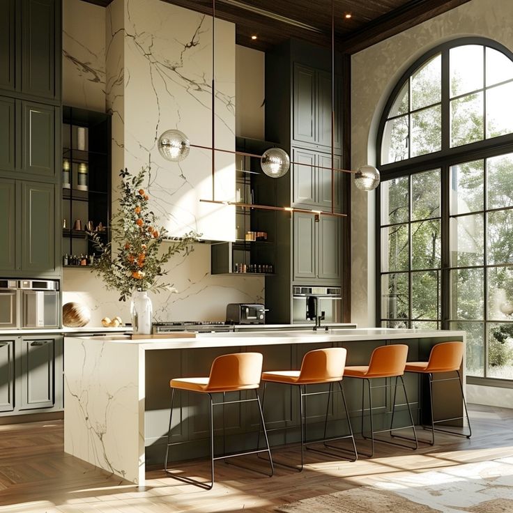 a kitchen with marble counter tops and orange chairs in front of an arched glass window