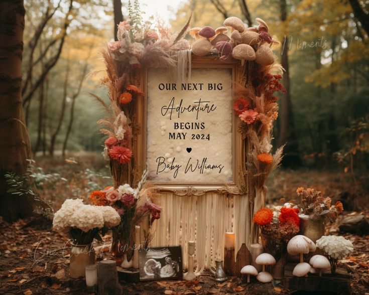 a wedding sign surrounded by flowers and mushrooms in the woods with an inscription on it that reads, our next big adventure begins may 24