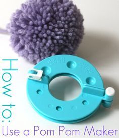 a blue pom - pom maker next to a purple ball of yarn