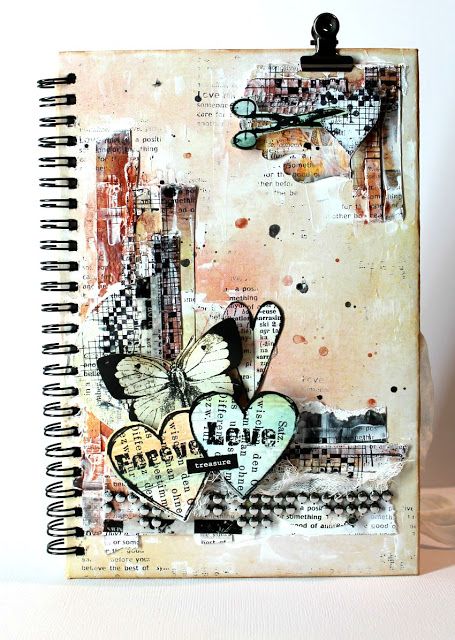 a notebook with an image of a butterfly on it