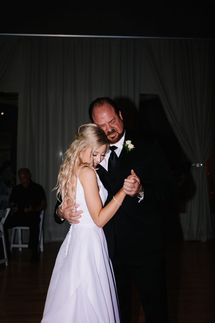 a bride and groom dance together on the dance floor