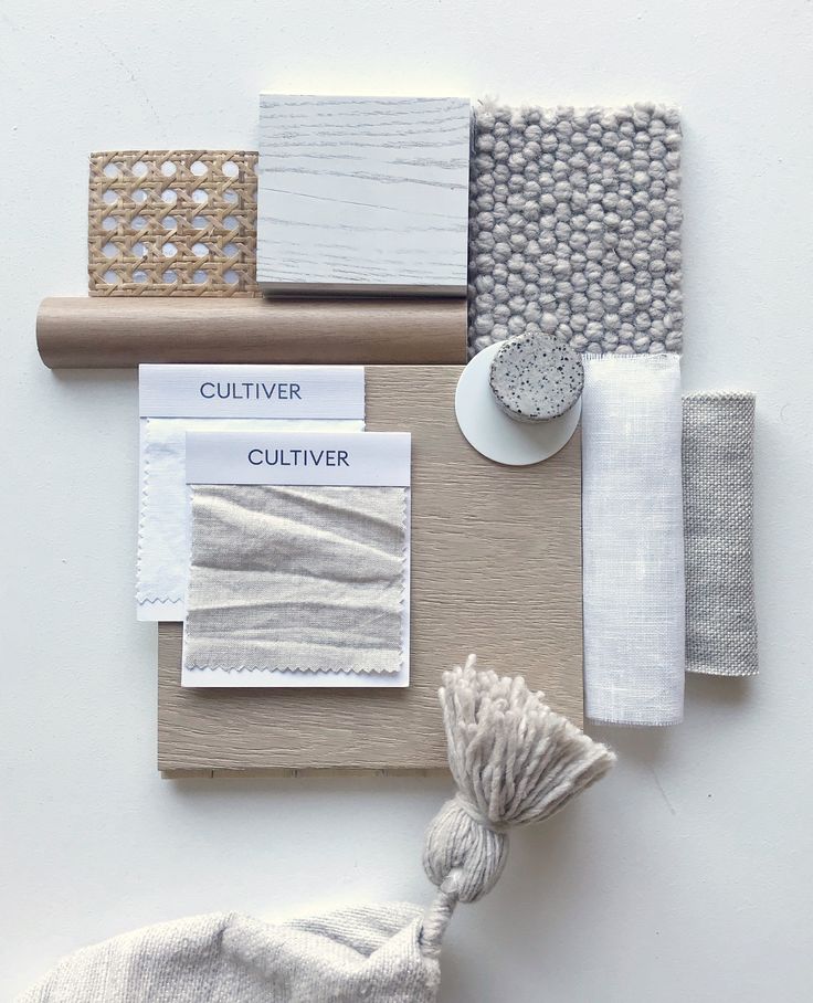 an assortment of different colors and materials on a white table cloth with a tassel