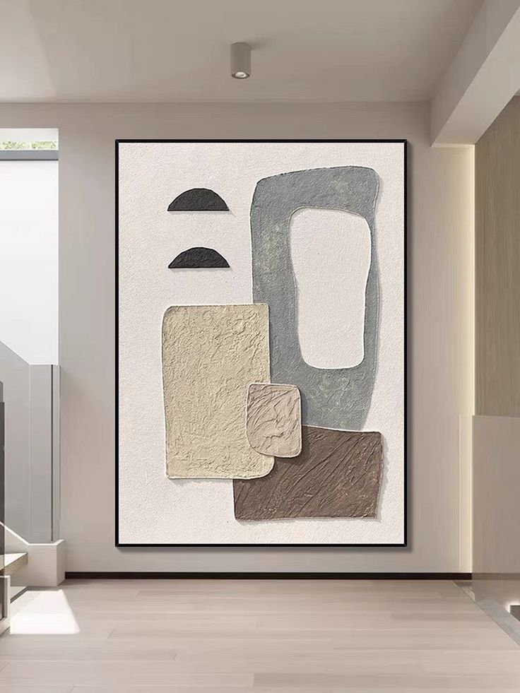 an abstract painting hangs on the wall next to stairs