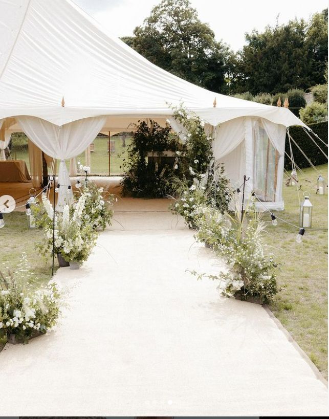 a white tent set up for a wedding ceremony