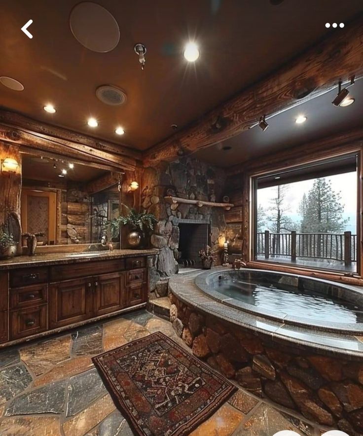 a large bathroom with stone walls and an oval jacuzzi tub in the middle