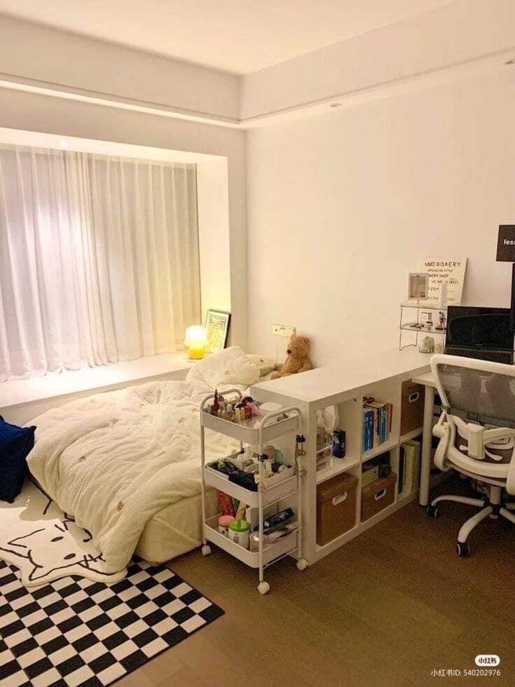 a bed room with a neatly made bed and desk