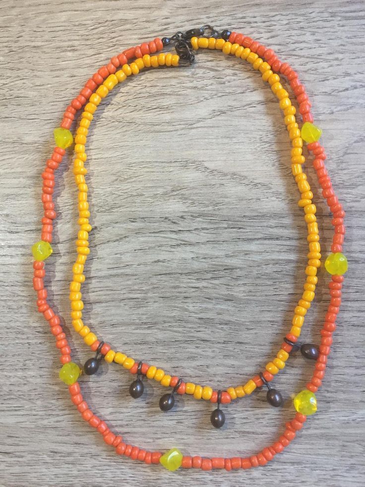 colorful, two necklaces for the price of one Orange Dangle Jewelry With Colorful Beads, Artisan Single Strand Orange Beaded Necklace, Adjustable Orange Artisan Necklace, Handmade Orange Long Necklace, Handmade Orange Necklace, Artisan Adjustable Orange Necklace, Artisan Orange Adjustable Necklace, Artisan Lariat Necklace With Colorful Beads, Artisan Lariat Jewelry With Colorful Beads