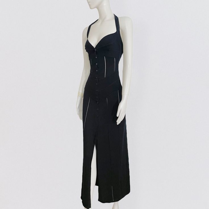 Vintage 90s maxi black backless dress by French brand Thierry Mugler. The backless dress has a close fit at the bust, which then flares out from the hips. The neckline has a sublime heart shape, typical of the brand. There are plays of transparency all along the length of the dress, as well as plays of tone on tone stripes insert, which emphasize the curves of the body. The dress closes with a series of snap buttons on the front. It is made from a thick, super stretch cotton knit. Label Size: 40 90s Thierry Mugler, Fitted Backless Bias Cut Midi Dress, Chic Fitted Maxi Dress With Back Opening, Fitted Bias Cut Backless Evening Dress, Fitted Backless Maxi Dress In Bias Cut, Backless Maxi Dress With Fitted Bodice, Fitted Long Backless Dress With Bias Cut, Fitted Black Midi Dress With Bias Cut, Fitted Bias Cut Maxi Dress