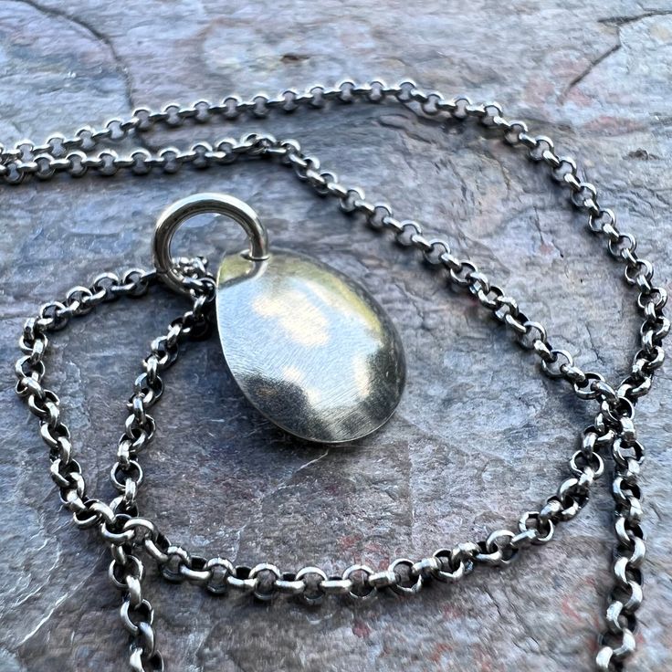 A small simple teardrop has been cut from a sheet of pure sterling silver. The teardrop was then slightly domed to give it a rounded shape. Pendant hangs from a sterling silver 1.75mm chain. The end of the chain features a lobster claw clasp and a 3-inch extender chain allowing the necklace to be slightly adjustable in length.Be sure to see all photos and video for size and color reference. Teardrop measures about 12x15mm Select your desired finish and length when ordering. The necklace is shown Minimalist Teardrop Pendant Necklace With Polished Finish, Minimalist Polished Teardrop Pendant Necklace, Minimalist Polished Finish Teardrop Pendant Necklace, Nickel Free Silver Teardrop Drop Necklace, Teardrop Pendant Necklace With Polished Finish, Nickel-free Silver Teardrop Drop Necklace, Sterling Silver Teardrop Jewelry With Silver Chain, Silver Sterling Silver Drop Necklace With Oval Pendant, Teardrop Pendant Necklace With Silver Chain