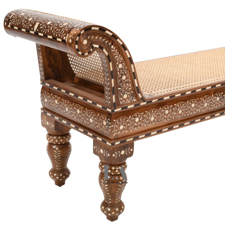 a bench made out of wood and wicker with an intricately carved seat on it