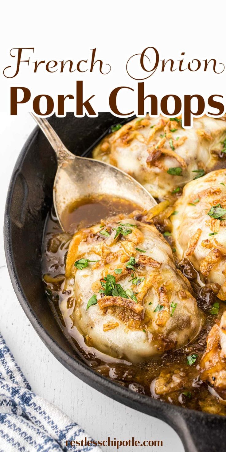 french onion pork chops in a cast iron skillet with a wooden spoon on the side