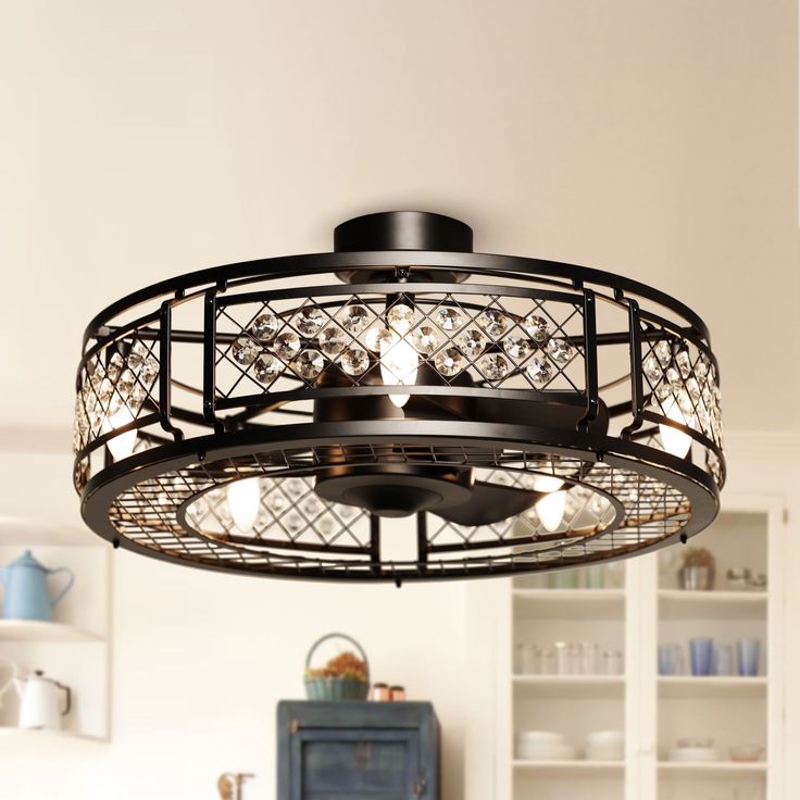 a chandelier hanging from the ceiling in a kitchen