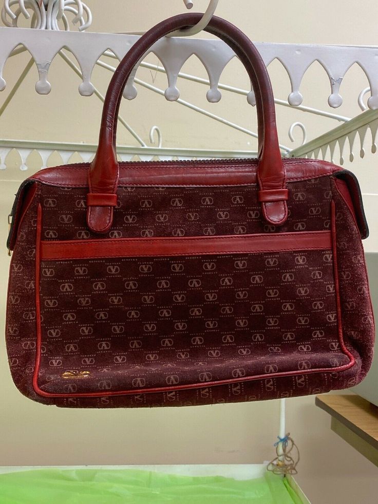 Offering auth.Vintage Valentino Red Handbag. Possibly 1980,s or earlier. Made of suede with leather accents and strap. Valentino logos all around the front and inside. Two front pockets There is some wear on the sides I took pictures of. Otherwise bag is clean esp.inside. Nice vintage look.Zipper is nice and smooth. Discoloring of the leather straps from use. Straps are 5” in length. Overall good condition for its age. Pre-owned Tote Shoulder Bag For Travel, Classic Pre-owned Bags For Daily Use, Classic Pre-owned Bags With Double Handle, Pre-owned Satchel Bag, Pre-owned Satchel Bag For Daily Use, Pre-owned Shoulder Bag For Shopping, Vintage Pre-owned Tote Bag, Pre-owned Satchel Bag For Shopping, Pre-owned Satchel For Shopping