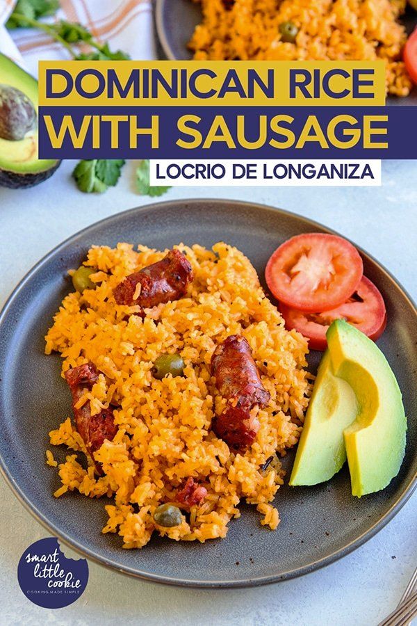 mexican rice with sausage on a plate with avocado, tomatoes and tomato slices