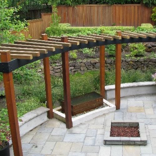 an outdoor patio with wooden posts and benches